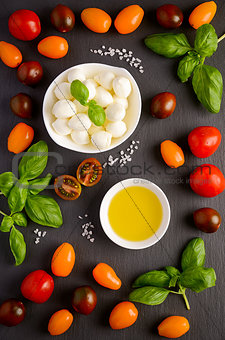 Italian food ingredients – mozzarella, tomatoes, basil and olive oil