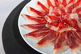 decorative arrangement of iberian cured ham on plate