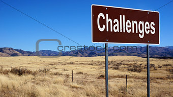 Challenges brown road sign