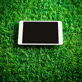 Tablet on artificial grass