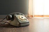 Gray telephone on hardwood floor