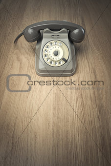 Vintage telephone on hardwood surface