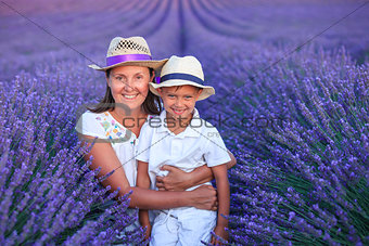 Boy with his mother in lavender summer field