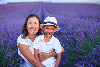 Boy with his mother in lavender summer field