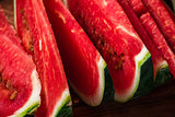 Juicy watermelon slices lying on wooden surface