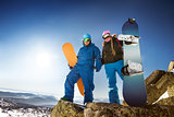 Happy snowboarding couple in winter mountains