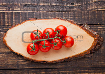 Fresh tomatoes on wooden board and grunge background