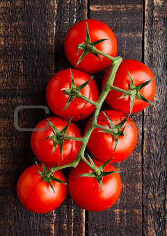 Fresh organic tomatoes on grunge wooden background