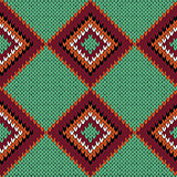 Knitting seamless quadrate pattern in warm colors over green