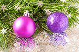 fir tree branch and Christmas toys bauble with confetti