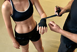 Young woman training in the gym with trainer