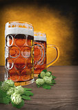 two glasses of oktoberfest beer with barley and hops on table - 3D render
