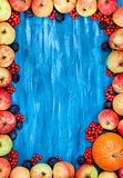 Autumn frame of apples, pumpkin, rowan on  painted blue wooden b
