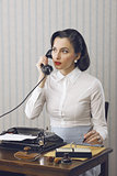 Woman talking on phone at desk