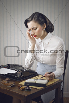 Worried woman sitting at desk in office