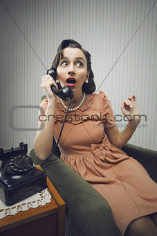 Woman talking on phone, looking surprised
