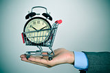 businessman with an alarm clock in a shopping cart