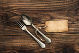 Old fork and spoon with paper label