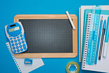 Chalkboard and stationery on blue background