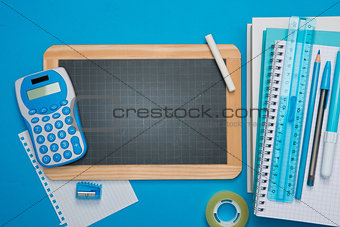 Chalkboard and stationery on blue background