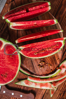 Watermelon slices and peels lying on the board