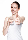 Beautiful girl holding glass with still healthy water
