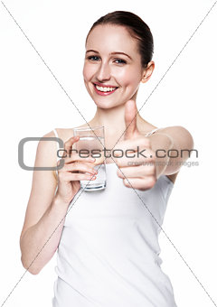 Beautiful girl holding glass with still healthy water