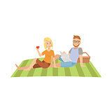 Woman Eating Apple And Man Reading Newspaper On Picnic