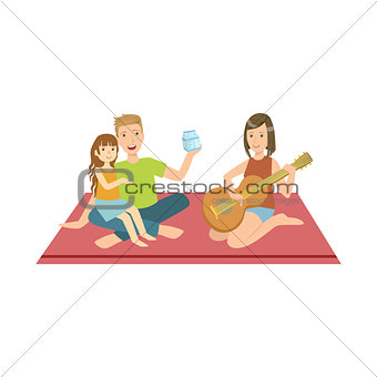 Family On Picnic With Mom Playing Guitar