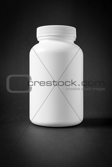 white plastic jar isolated on black