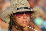 young girl in sunglasses and cowboy hat