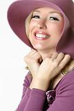 Playful woman in large brimmed sunhat