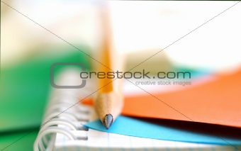 Pencil and note-paper on the copy-book