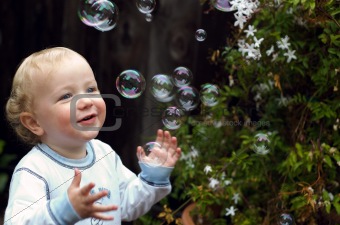 Young boy playing with bubbles