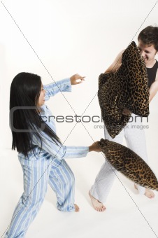 couple fighting with pillows
