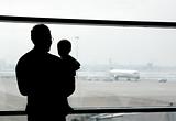 father and son looking at airplanes