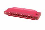 Isolated pink harmonica on white