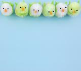 row of easter chicks on blue background