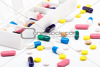 Pills and capsules in and out of pill organizer