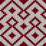 Knitting ornate seamless pattern in muted dark red and white col