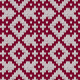 Knitting ornate seamless pattern in dark red and white colors