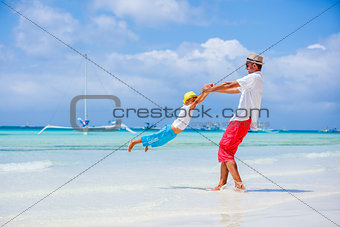 Father and son having fun on beach