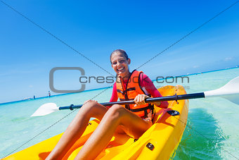 Girl paddling in kayak