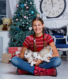 Girl sitting with Husky puppies