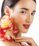 young pretty brunette woman with red flower amaryllis close up isolated on white background. Fancy fashion makeup, bright lipstick, creative Ombre manicured nails