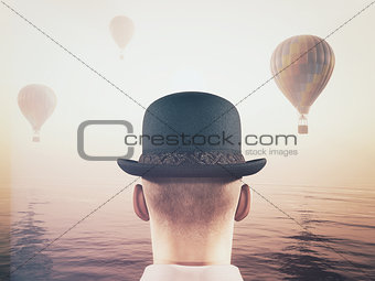 Man looks at hot air balloons