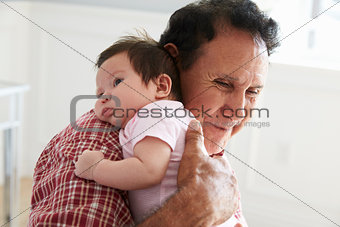 Proud Grandfather Holding Baby Granddaughter