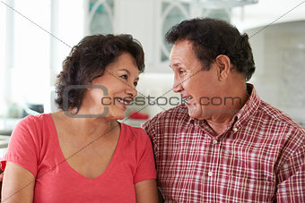 Head And Shoulders Shot Of Senior Hispanic Couple At Home