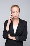 Beautiful young caucasian businesswoman talking on mobile phone.