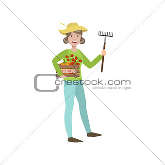 Woman Farmer Holding The Rake And Crate Of Vegetables